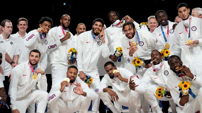 The U.S. men’s basketball team poses for photos with their gold medals during the medal ceremony at the 2020 Summer Olympics, Saturday, Aug. 7, 2021, in Tokyo, Japan.