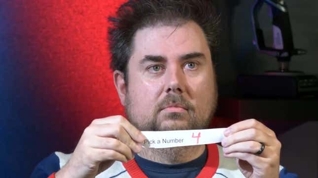 Jeff holding a piece of paper with the number 4 on it. 