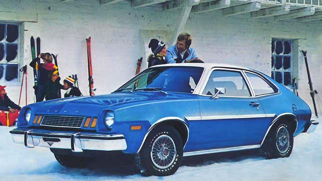 A photo of a blue Ford Pinto parked on snow. 