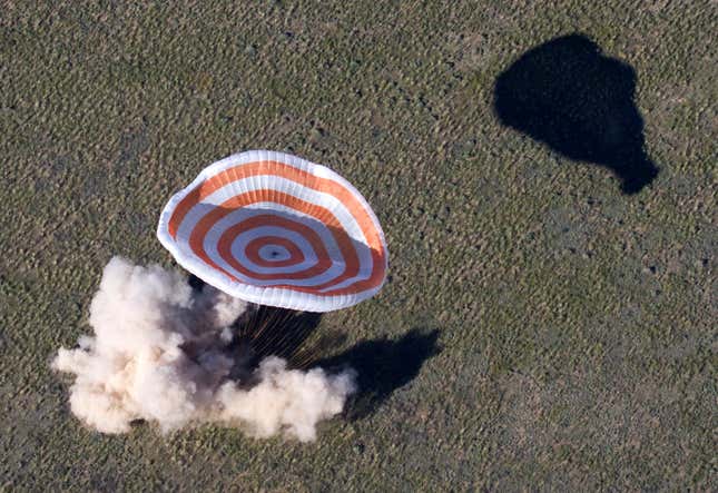 The Russian Soyuz space capsule, carrying U.S. astronaut Thomas Marshburn, Russian cosmonaut Roman Romanenko and Canadian astronaut Chris Hadfield, lands some 150 km (90 miles) southeast of the town of Dzhezkazgan in central Kazakhstan, Tuesday, May 14, 2013. The Soyuz space capsule carrying a three-man crew returning from a five-month mission to the International Space Station landed safely Tuesday on the steppes of Kazakhstan. (AP Photo/Sergei Remezov, Pool)
