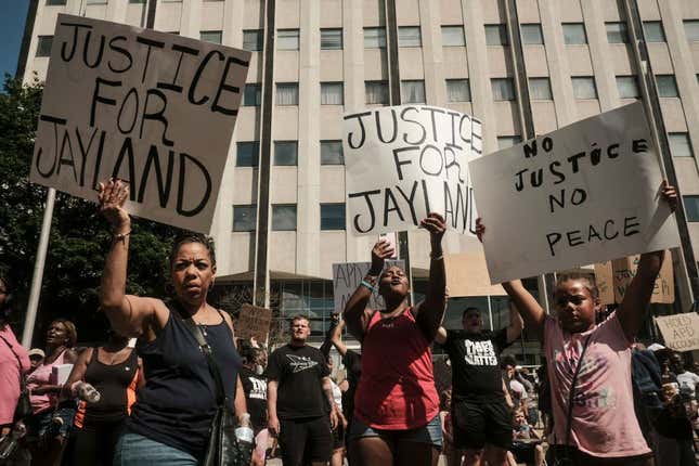 Demonstrators hold “Justice for Jayland” signs as they gather outside Akron City Hall to protest the killing of Jayland Walker, shot by police, in Akron, Ohio, July 3, 2022.