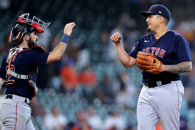 Aug 24, 2023; Houston, Texas, USA; Boston Red Sox catcher Connor Wong (12) congratulates Boston Red Sox relief pitcher Mauricio Llovera (68) following the final out against the Houston Astros during the ninth inning at Minute Maid Park.