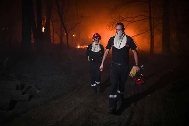 Firefighters work at a fire at La Teste de Buch, France, July 15, 2022