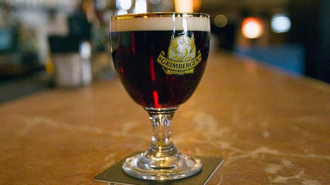 Beer glass full of dark amber Grimbergen beer
