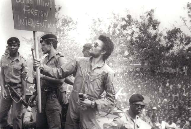 Rawlings reading a placard at a 1981 demonstration in Nicholson Stadium, Accra.