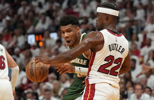 Apr 24, 2023; Miami, Florida, USA; Miami Heat forward Jimmy Butler (22) defends Milwaukee Bucks forward Giannis Antetokounmpo (34) in the first quarter during game four of the 2023 NBA Playoffs at Kaseya Center.