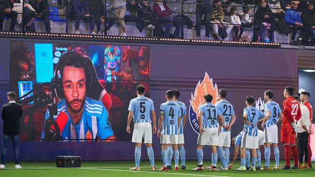 The streamer TheGrefg is seen speaking to his team, Saiyans FC, from a screen at the Cupra Arena.