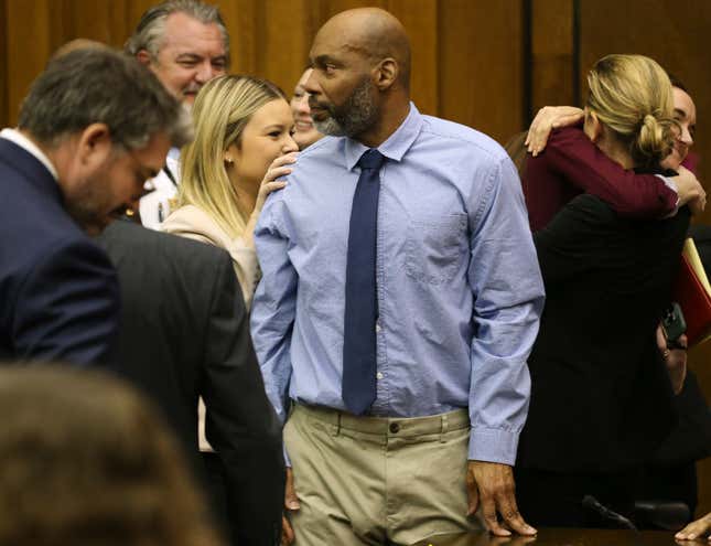Lamar Johnson, center looks toward friends and family members as his attorneys celebrate on Tuesday, Feb. 14, 2023, after St. Louis Circuit Judge David Mason vacated his murder conviction during a hearing in St. Louis, Mo. Johnson served nearly 28 years of a life sentence for a killing that he has always said he didn’t commit.