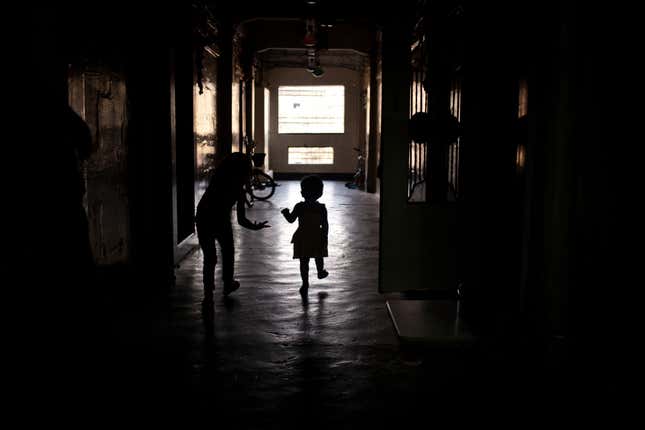 Children play in a corridor of the BDD chawl.