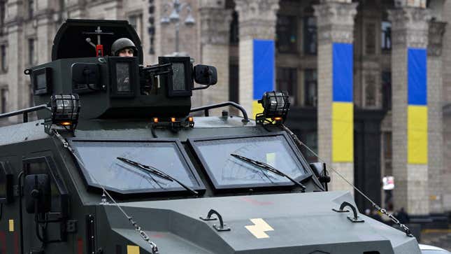 A Ukrainian service member sits in the gunner's seat of a vehicle in Kyiv. 