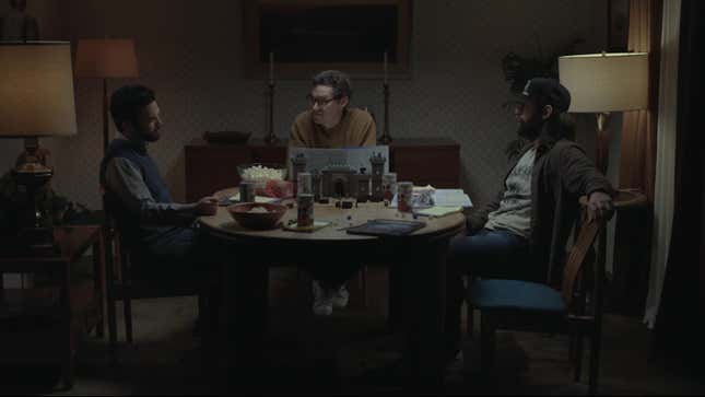 Three nerds sit at a circular table and play Dungeons & Dragons.