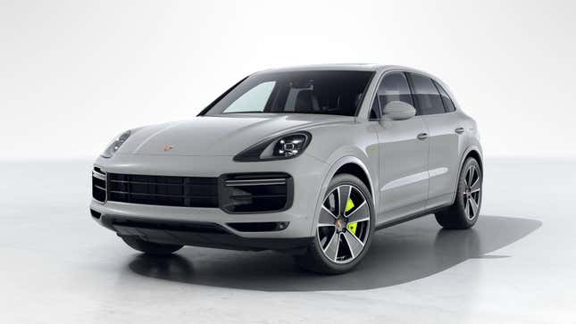 A 2023 Porsche Cayenne Turbo S E-Hybrid in Chalk is parked in front of a white wall.