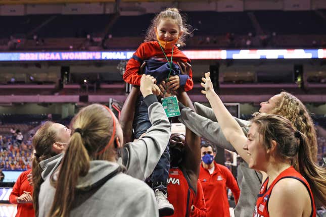 Arizona women’s basketball team hoists coach Adia Barnes son, Matteo, after beating UConn in Final Four.