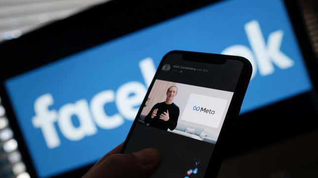 A smartphone showing Facebook founder Mark Zuckerberg talking about the "metaverse" overlaid over the Facebook logo.