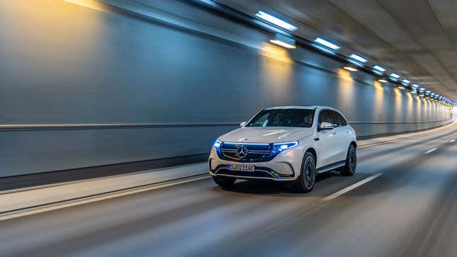 A white Mercedes EQC electric SUV driving in a tunnel 