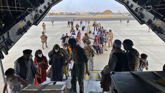 People board a Spanish airforce A400 plane as part of an evacuation plan at Kabul airport in Afghanistan, Wednesday Aug. 18, 2021. 