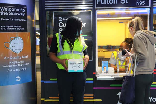 MTA employee Shanita Hancle gives out masks at the Fulton Street subway station amid hazy conditions due to smoke from the Canadian wildfires on June 08, 2023, in New York City. 