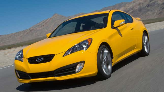A photo of a yellow Hyundai Genesis coupe driving on a track. 
