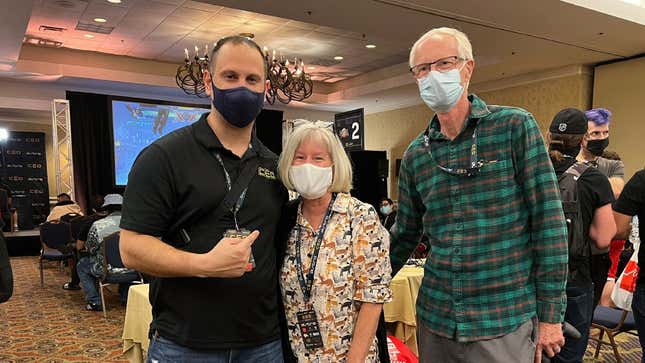 Kim and Craig Cutchin smile behind their face masks as they pose for a photo with Alex Jebailey at CEO 2021.