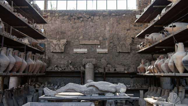 A body cast and amphorae in a storage area in Pompeii.