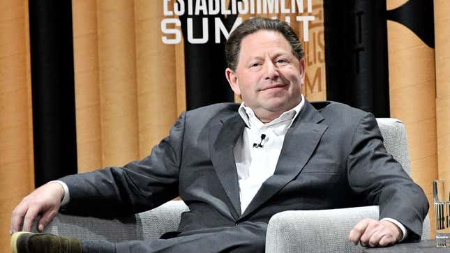 Bobby Kotick sitting in a large chair, smirking.