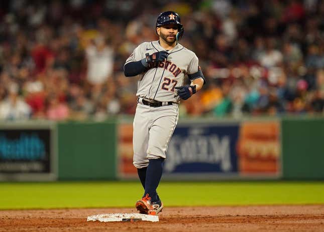 Aug 28, 2023; Boston, Massachusetts, USA; Houston Astros second baseman Jose Altuve (27) hits a double against the Boston Red Sox in the third inning at Fenway Park.