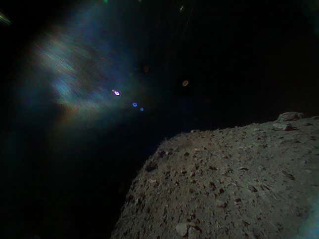 Image captured by Rover-1B on September 21 at around 13:07 JST. This color image was taken immediately after separation from the spacecraft. The surface of Ryugu is in the lower right. The coloured blur in the top left is due to the reflection of sunlight when the image was taken.