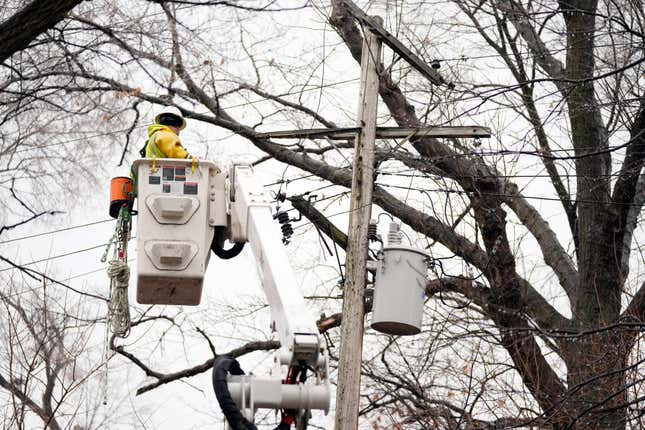 A DTE contractor crew works on a power line, Monday, Feb. 27, 2023, in northwest Detroit. 