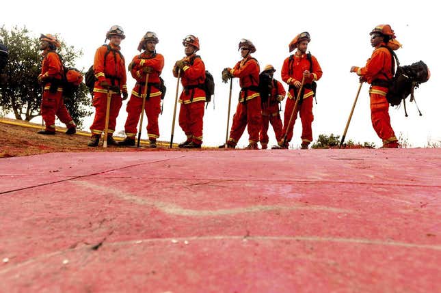 In this Aug. 17, 2020, photo, inmate firefighters - notable by their bright orange fire gear compared to the yellow worn by professional firefighters - prepare to take on the River Fire in Salinas, Calif. The California Senate on Thursday, June 23, 2022, rejected a proposal to ban involuntary servitude as punishment for a crime after Gov. Gavin Newsom’s administration warned it could cost taxpayers billions of dollars by forcing the state to pay inmates who work while in prison a $15-per-hour minimum wage.