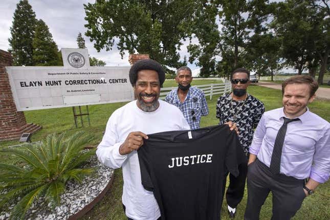 Sullivan Walter, 53, left, holds a shirt near Elayn Hunt Correctional Center in St. Gabriel, La., with, left to right, his brothers Corner Walter, Jr. and Byron Walter, Sr., and Innocence Project New Orleans legal director Richard Davis, just after his release on Thursday, Aug. 25, 2022. 
