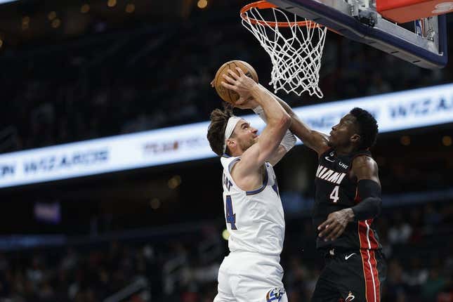 Apr 7, 2023; Washington, District of Columbia, USA; Washington Wizards forward Corey Kispert (24) is fouled while shooting the ball by Miami Heat guard Victor Oladipo (4) in the fourth quarter at Capital One Arena.