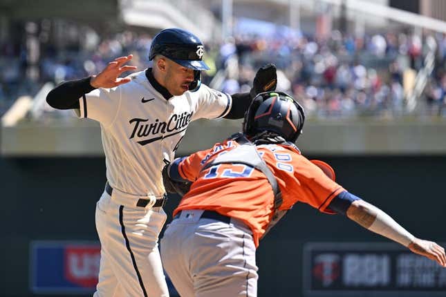 Apr 8, 2023; Minneapolis, Minnesota, USA; Minnesota Twins shortstop Carlos Correa (4) is tagged out at home by Houston Astros catcher Martin Maldonado (15) during the second inning at Target Field.