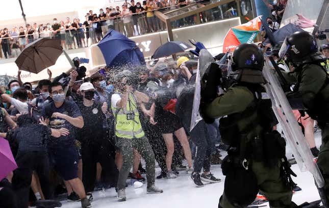 Riot police use pepper spray to disperse people inside a mall in Hong Kong, July 14, 2019.