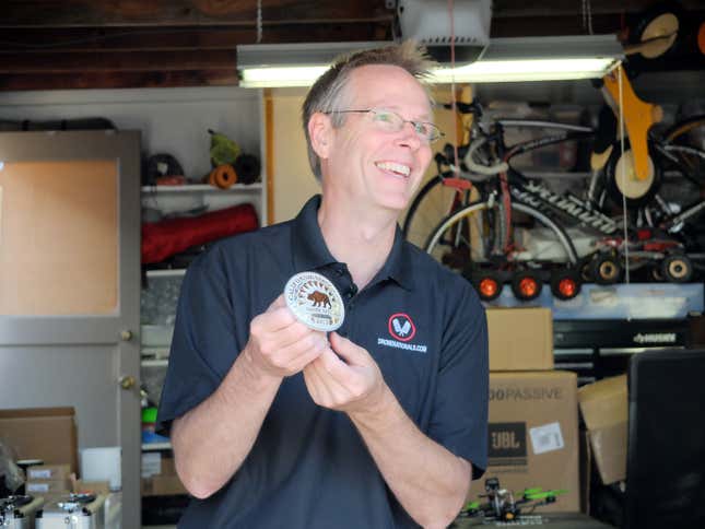 Race organizer Scot Refsland, at home, with the winner’s buckle.