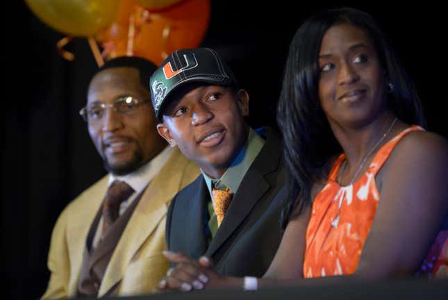 Ray Lewis III, center, smiles as he is introduced during a national signing day ceremony in the Lake Mary Prep auditorium as his father, former Baltimore Ravens linebacker Ray Lewis Jr., left, and his mother, Tatyana McCall, watch.