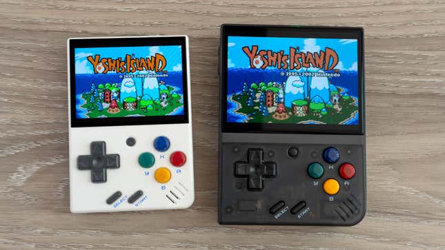 The Miyoo Mini handheld next to the Miyoo Mini Plus on a wooden table with Yoshi's Island on screen.