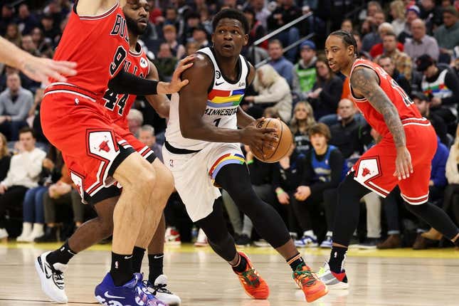 Dec 18, 2022; Minneapolis, Minnesota, USA; Minnesota Timberwolves guard Anthony Edwards (1) dribbles while Chicago Bulls center Nikola Vucevic (9) defends during the first quarter at Target Center.