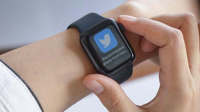 An Apple Watch on a wrist displaying a notification from Twitter