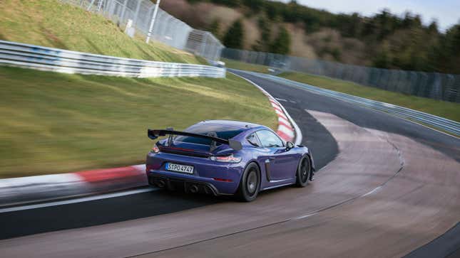 A purple Porsche 718 GT4 RS takes a corner on the Nurburgring