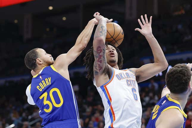 Jan 30, 2023; Oklahoma City, Oklahoma, USA; Golden State Warriors guard Stephen Curry (30) strips the ball away from Oklahoma City Thunder forward Jaylin Williams (6) during the second half at Paycom Center.