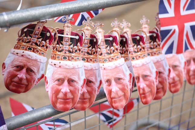 Bunting featuring the cutout head of King Charles III in a crown seen on The Mall in London.