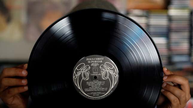 A man shows a vinyl record at "El Pollo Musical" (The Musical Chicken) record store in San Salvador