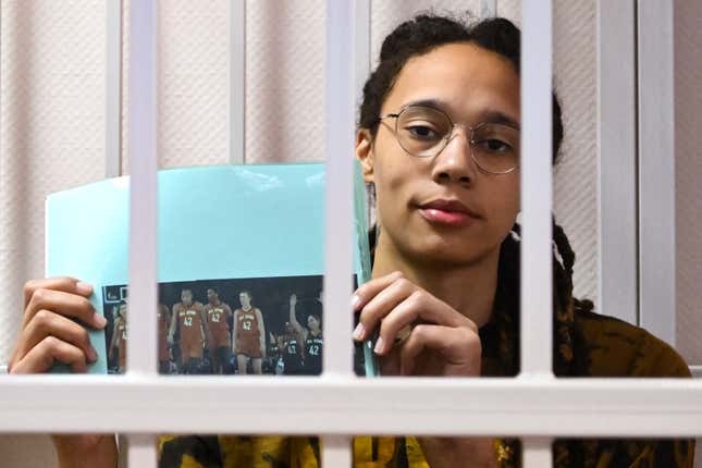 Brittney Griner sits inside a defendants’ cage with a picture depicting her WNBA fellow players wearing jerseys with her number, 42, during the leagues All-Star Game, during a hearing at the Khimki Court in the town of Khimki outside Moscow on July 15, 2022. 