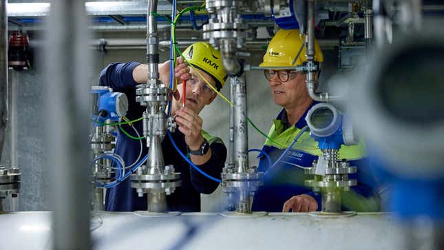 A photo of two employees at a Quantafuels plant. 