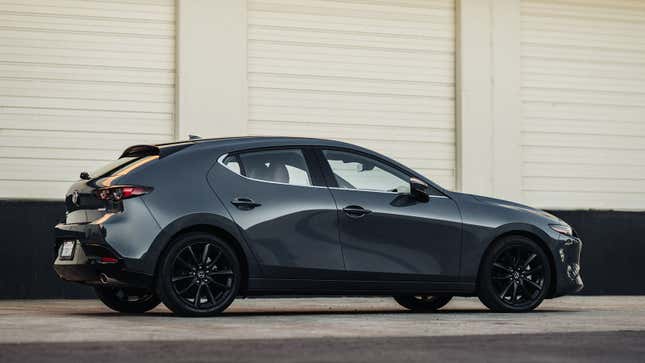 A photo of a grey Mazda3 hatchback. 