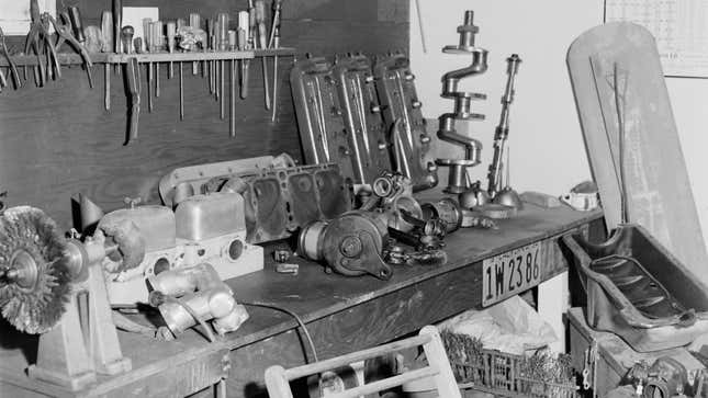 A black and white photo of a workshop bench. 