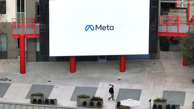 In an aerial view, a worker walks by a large video monitor on the Meta campus on February 02, 2023 in Menlo Park, California. Facebook's parent company Meta is reportedly planning on making a Twitter-like app.