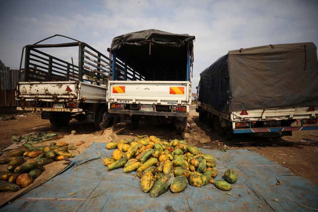 Rotten fruits are seen behind trucks at a street market while the spread of the coronavirus disease (COVID-19) continues, in Abuja, Nigeria April 9.