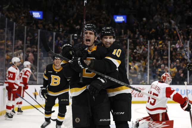 Mar 11, 2023; Boston, Massachusetts, USA; Boston Bruins left wing A.J. Greer (10) hugs right wing Garnet Hathaway (21) after he scored the go ahead goal against the Detroit Red Wings during the third period at TD Garden.