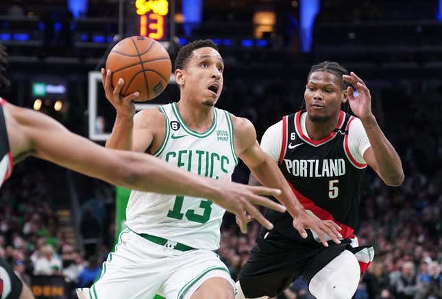 Mar 8, 2023; Boston, Massachusetts, USA; Boston Celtics guard Malcolm Brogdon (13) drives the ball against Portland Trail Blazers forward Cam Reddish (5) in the second half at TD Garden.
